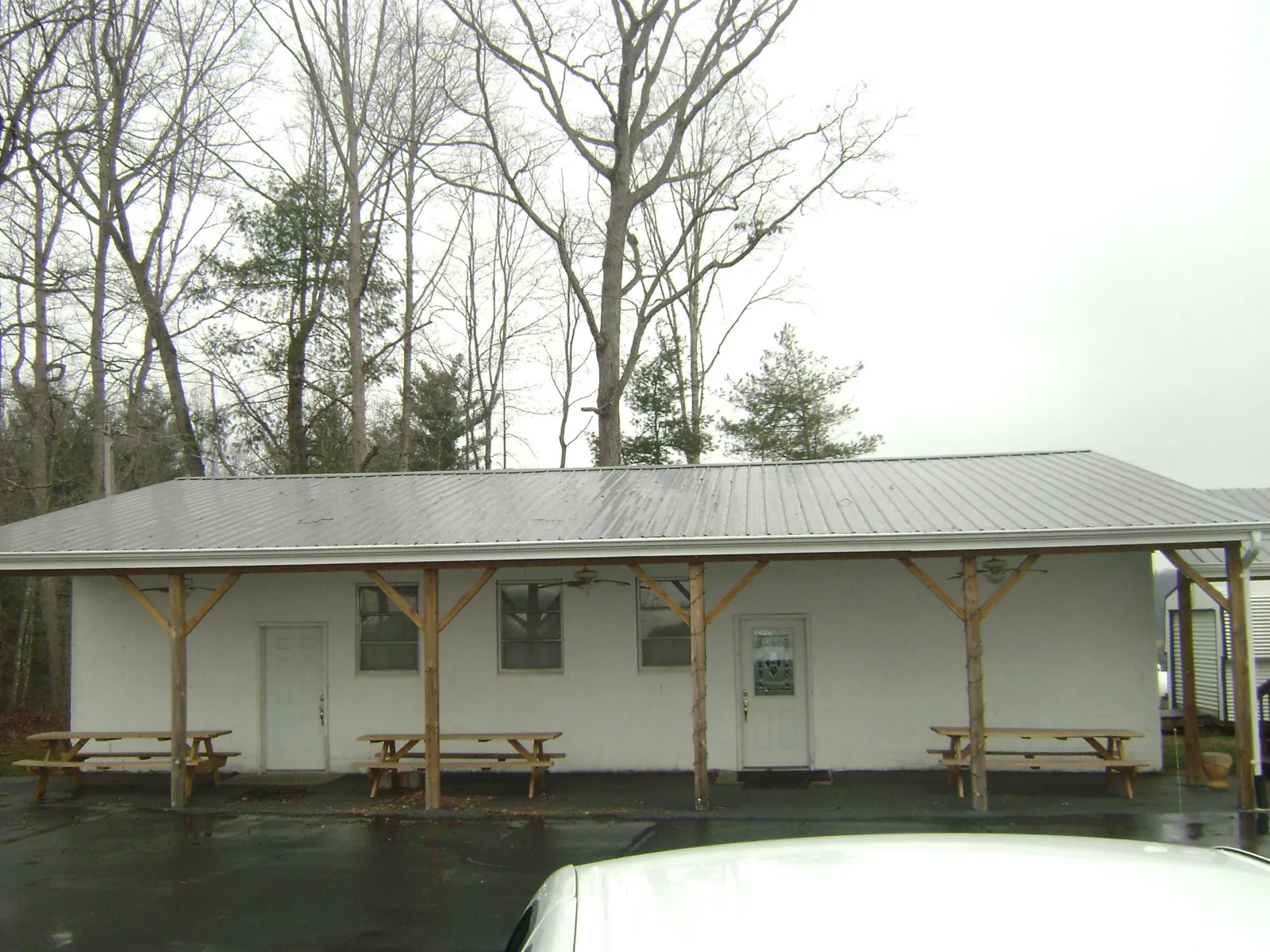Gray metal roof over a block building with a timber post porch in Milton Freewater
